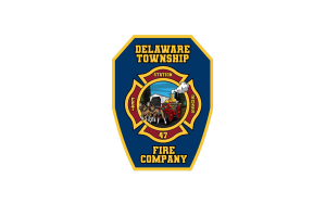 A blue and gold badge for Delaware Township Fire Company Station 47, featuring an old-fashioned fire engine and horses at the center, surrounded by fire service symbols.